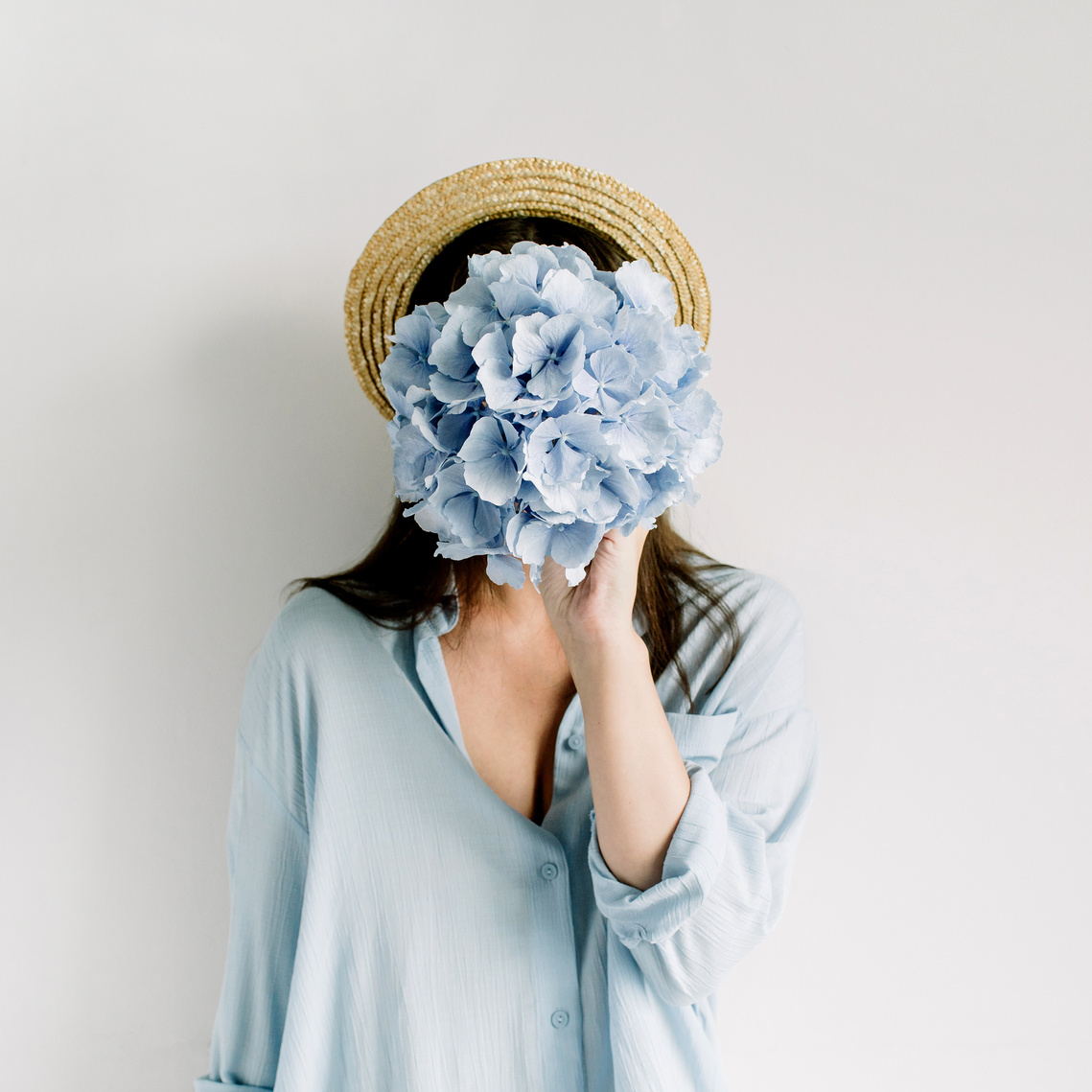 Woman hold blue hydrangea flower bouquet 